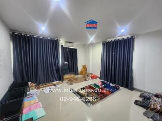 Photo of a room with boxes and curtains