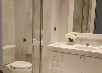 Modern bathroom with glass shower and white cabinetry