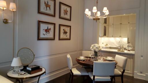 Elegant dining area with round table, chairs, and kitchen in the background