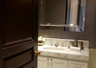 Modern bathroom with dark door and white vanity