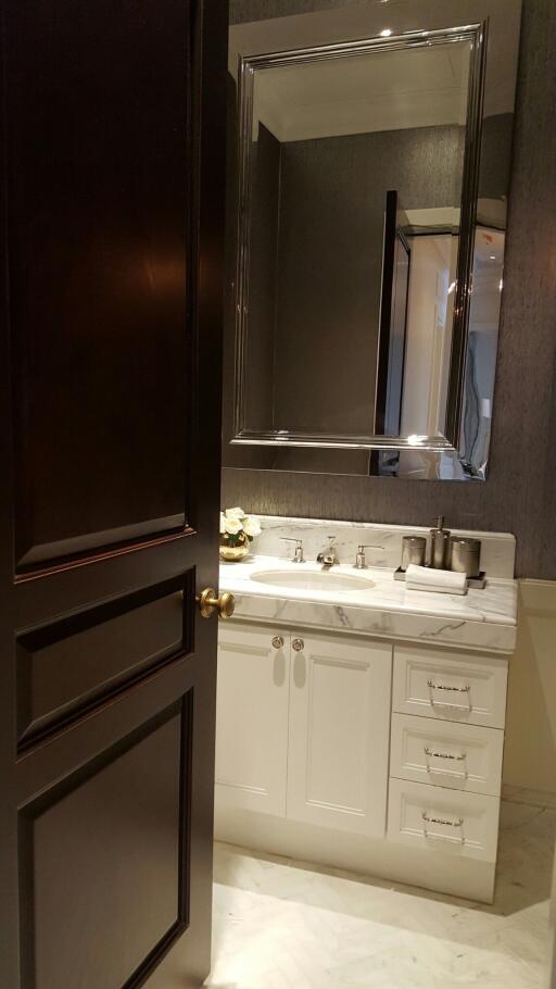 Modern bathroom with dark door and white vanity