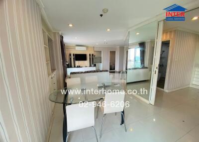 Modern dining area with glass table and white chairs