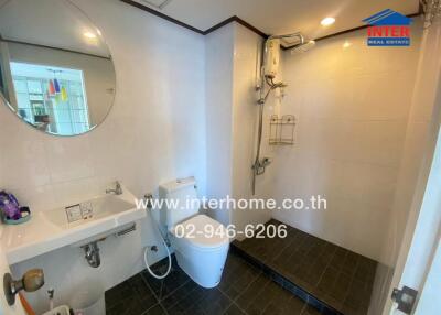 Modern bathroom with shower, sink, and toilet area