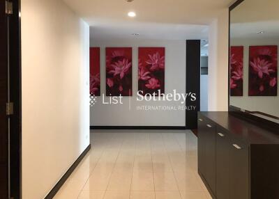 Modern hallway with floral paintings and sleek cabinetry