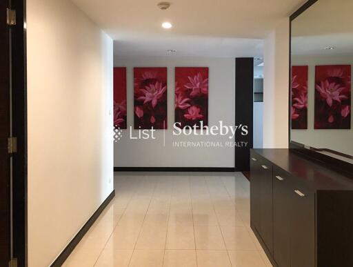 Modern hallway with floral paintings and sleek cabinetry