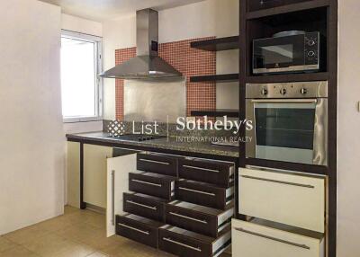 Modern kitchen area with appliances and storage