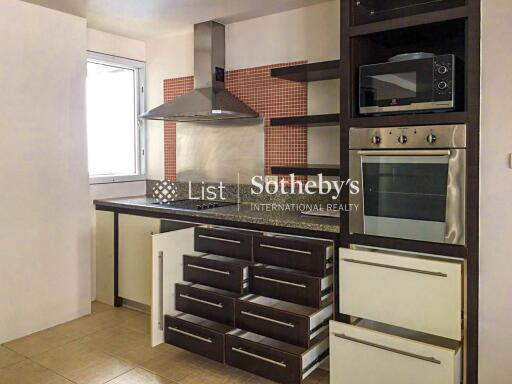 Modern kitchen area with appliances and storage