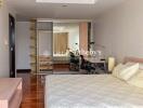 Spacious bedroom with large mirror wardrobe and desk