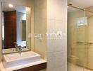 Modern bathroom with sink, mirror, and shower