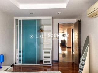 Modern bedroom with wardrobe and wooden floor