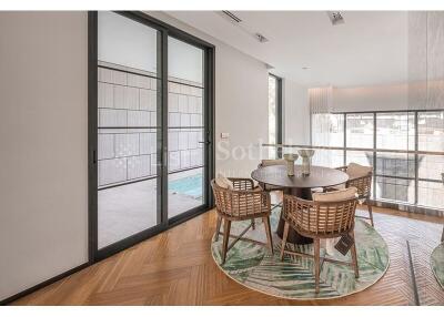 Modern dining area with glass doors leading to a balcony