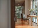 Spacious hallway with wooden flooring, large window, and a desk