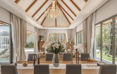 Elegant spacious dining room with a chandelier and large windows