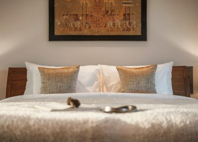 Cozy bedroom with decorative pillows and wall art