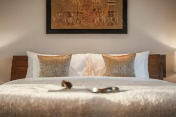 Cozy bedroom with decorative pillows and wall art