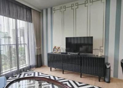 Living room with TV unit and balcony view