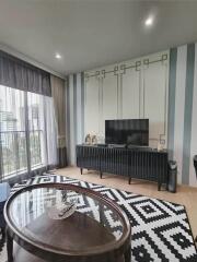 Living room with TV unit and balcony view