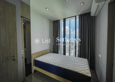 Bedroom with large window and city view