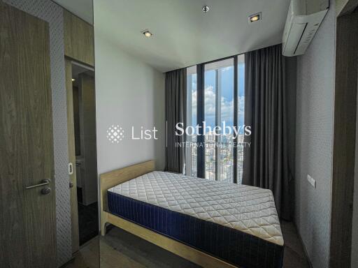 Bedroom with large window and city view