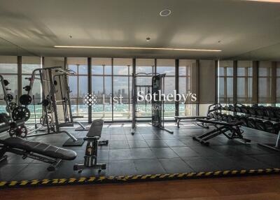 Spacious gym with modern fitness equipment and city view