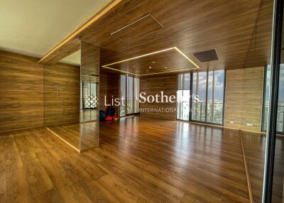 Modern living space with wooden flooring and mirrored walls