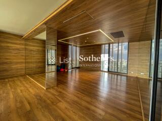 Modern living space with wooden flooring and mirrored walls