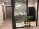 Modern kitchen with glass partition and plants