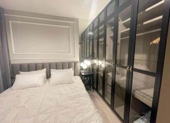 Elegant bedroom with glass-fronted wardrobes