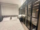 Elegant bedroom with glass-fronted wardrobes