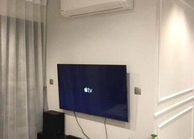 Modern living room with wall-mounted TV and air conditioner