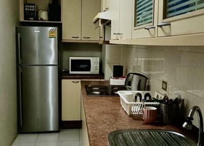 Modern kitchen with stainless steel appliances and overhead cabinets