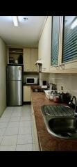 Modern kitchen with stainless steel appliances and overhead cabinets