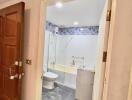 Entryway view of a bathroom with tile walls and floor