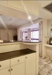 Modern kitchen with black countertop and ample lighting