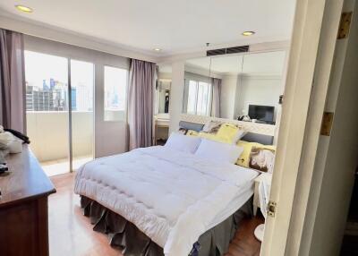 Spacious bedroom with large window and city view