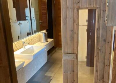 Modern bathroom with double sinks and wooden door