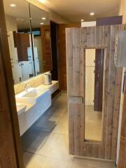 Modern bathroom with double sinks and wooden door