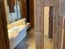 Modern bathroom with double sinks and wooden door