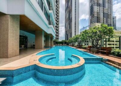 Outdoor swimming pool in modern building complex