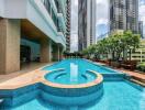 Outdoor swimming pool in modern building complex