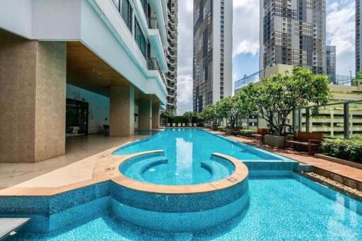 Outdoor swimming pool in modern building complex