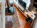 High angle view of a modern living room with a television and desk area