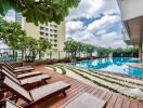 Modern residential outdoor pool area with loungers and greenery