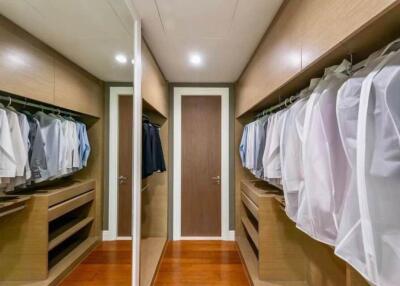 Spacious walk-in closet with wooden shelves and ample hanging space