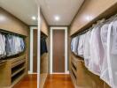 Spacious walk-in closet with wooden shelves and ample hanging space