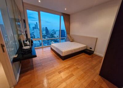 Bedroom with large window and city view