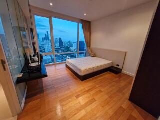 Bedroom with large window and city view