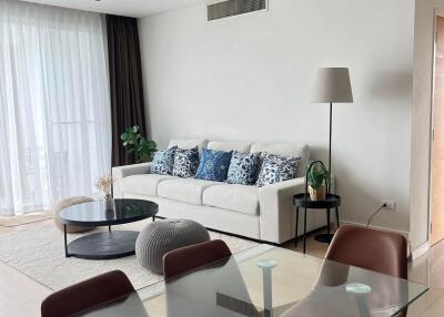 Modern living room with glass dining table and white sofa