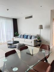 Modern living room with glass dining table and white sofa