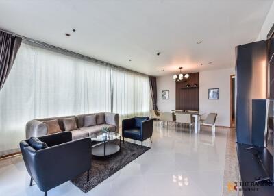 Modern living room with ample natural light and contemporary furnishings